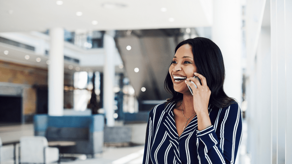 a woman taking on a phone and smiling